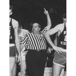 Referee Jim Enright Calling Plays and Using Hand Signals During a Game 