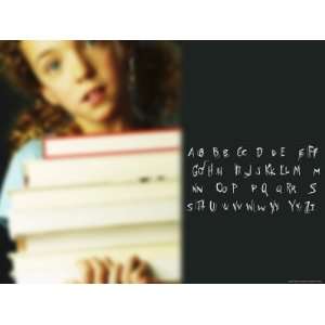  Little Girl with Pile of Text Books Beside Alphabet 