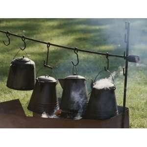  Four Metal Coffee Pots Steaming over an Outdoor Grill 